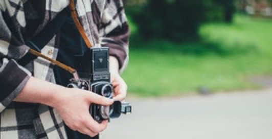 person holding film camera